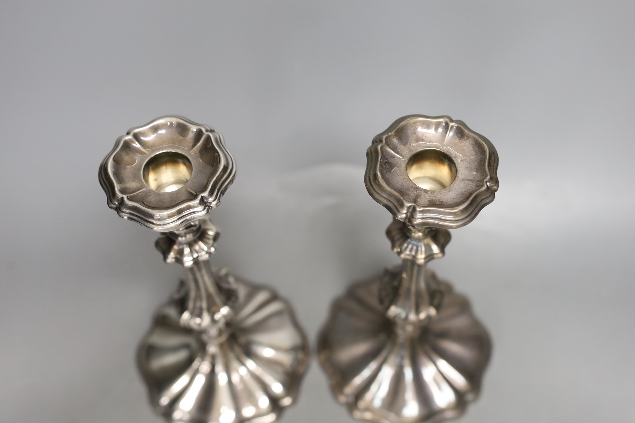A pair of Rococo-style plated candlesticks - 24cm tall